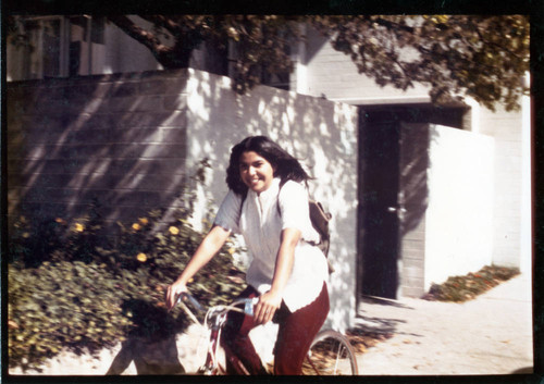 Student riding bicycle, Pitzer College