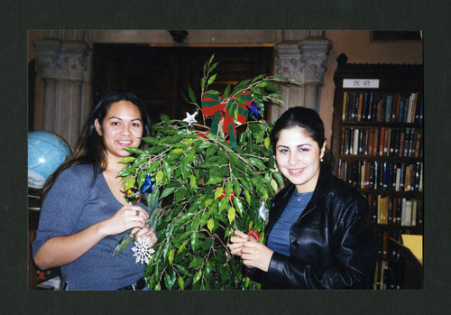 Scripps students decorating Denison Library's Christmas tree, Scripps College