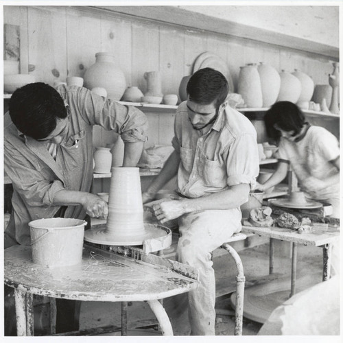 Henry Takemoto and student with pottery wheel, Scripps College