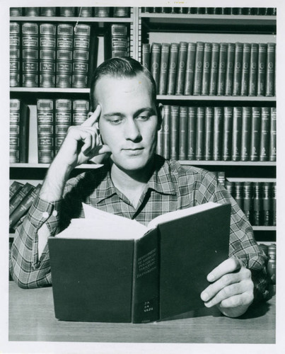 Student reading in Honnold Library, Claremont University Consortium