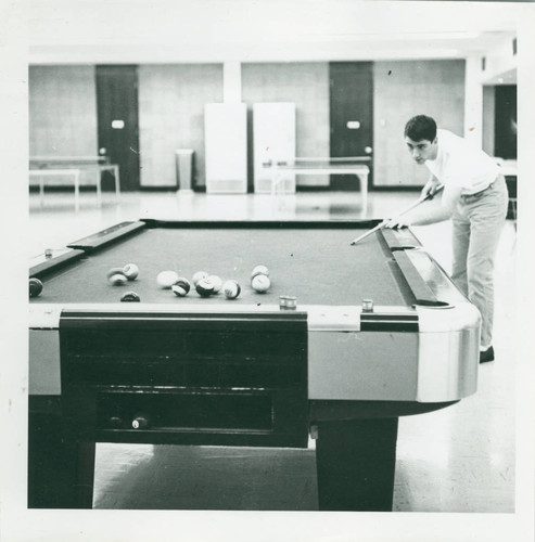 Student playing pool, Harvey Mudd College