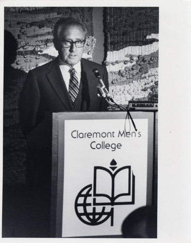 Henry Kissinger standing behind a podium, Claremont McKenna College