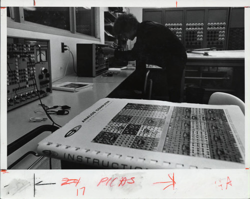 A man adjusts a computer, Scripps College