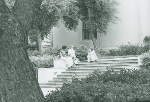 Sitting on the steps outside Honnold Library