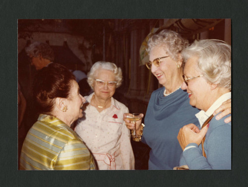 Dorothy Drake conversing with friends at Denison Library's 50th birthday party, Scripps College