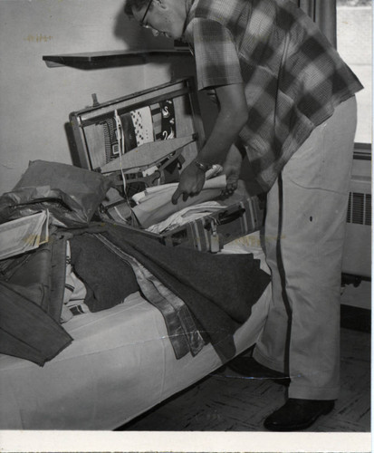 Student Packing a Suitcase