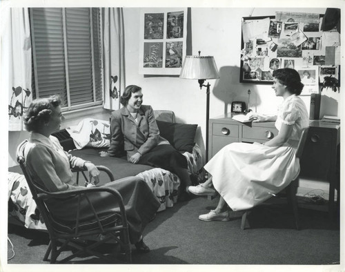 Three women, seated, dormitory room, Pomona College