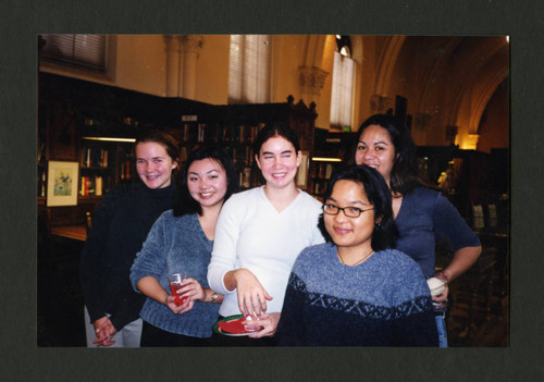 Scripps students smiling together at Denison Library's 2000 Christmas tea, Scripps College