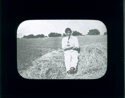 Student on haystack, Pomona College