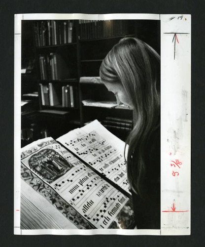 Scripps student examining Denison Library's 16th Century Gradual, Scripps College