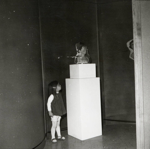 Young girl looks at sculpture, Scripps College