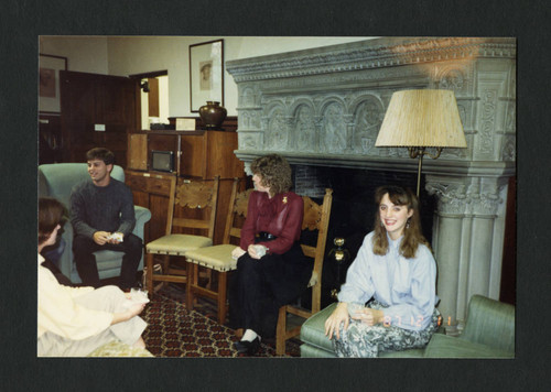 Students and librarians sitting together during Denison Library's Christmas Tea, Scripps College