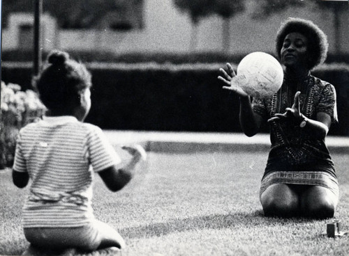 Woman and young girl playing catch, Pitzer College