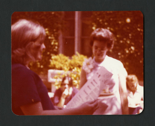 Judy Harvey Sahak presenting Jane Shanck with the "proclamation" for her party, Scripps College