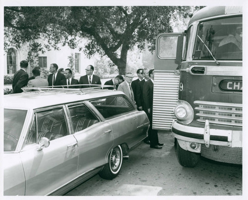 Men boarding a bus, Pomona College