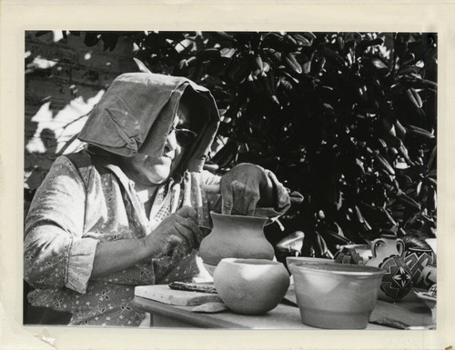 Woman works on pottery, Scripps College