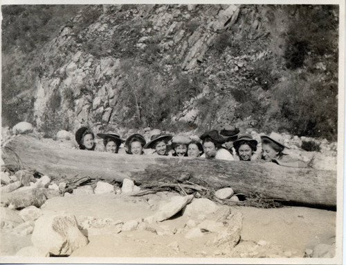Women behind a log, Pomona College