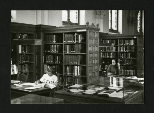 Two students separately studying in Denison Library, Scripps College