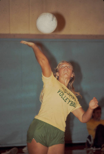 Student serving during volleyball game, Scripps College