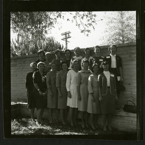 Scripps alumnae standing side by side in a courtyard at their reunion celebration, Scripps College