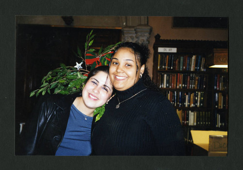 Two Scripps students smiling at Denison Library's Christmas tea, Scripps College