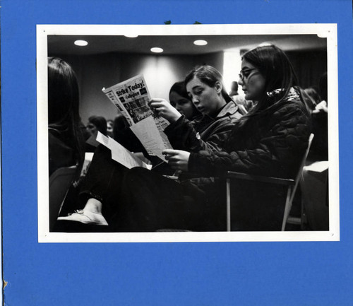 Student reading a newspaper, Pitzer College