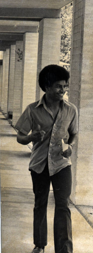 Student walking under the arcades, Pitzer College