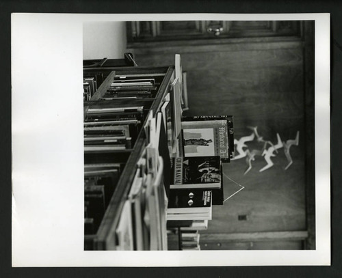 Bookshelf covered in unshelved books in Denison Library, Scripps College