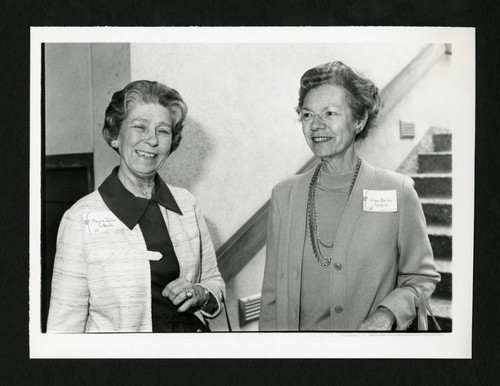 Two Scripps alumnae from the class of 1935 smiling at each other, Scripps College