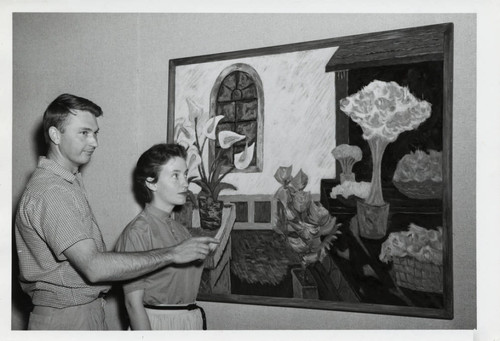 Man and woman with painting, Scripps College