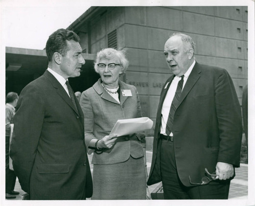 Three individuals standing near a building, Claremont McKenna College