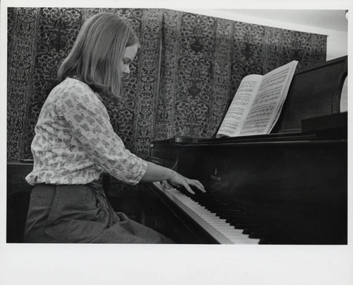 Woman plays piano, Scripps College