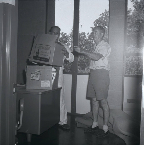 Kingston Hall interior with men moving boxes, Harvey Mudd College