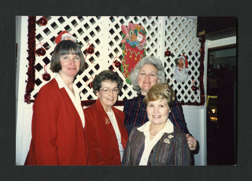 Four festive colleagues at the staff Christmas breakfast, Scripps College