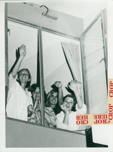 Students wave from window, Scripps College