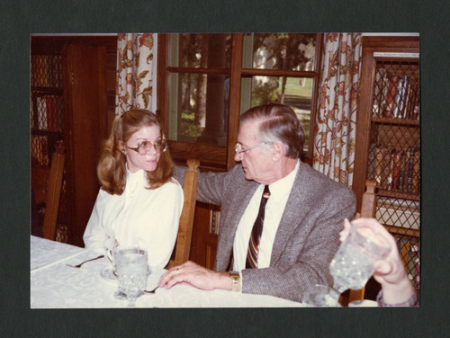 Sheryl Fierro and Floyd Ethridge sit together at Dorothy Drake's portrait presentation, Scripps College