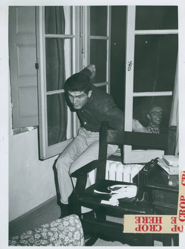 Student climbing through window, Harvey Mudd College