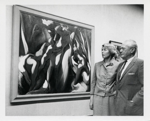 Man and woman observe painting, Scripps College