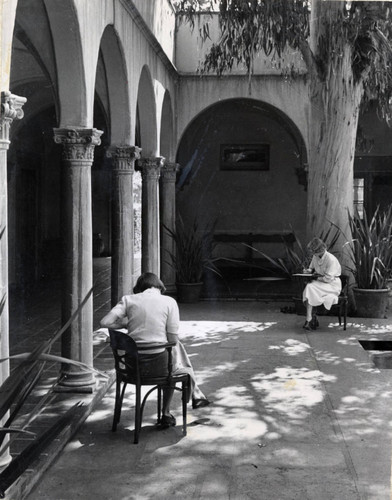 Two students writing in Eucalyptus Court, Scripps College