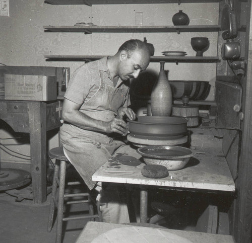 Harrison McIntosh with pottery wheel, Scripps College