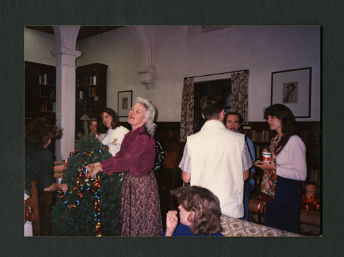 Judy Harvey Sahak decorating a christmas tree in Denison Library, Scripps College