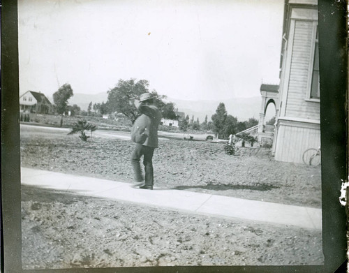 Student beside Holmes Hall, Pomona College