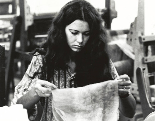 Textiles student with cloth, Scripps College