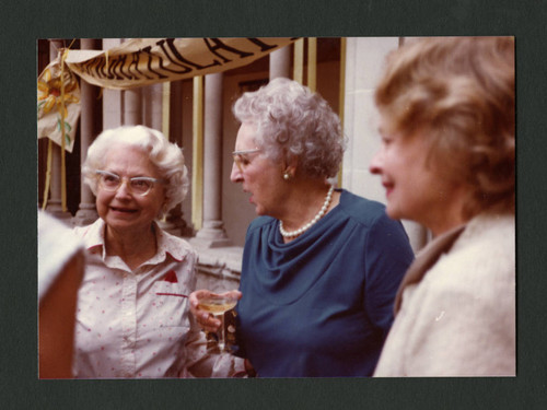 Three women converse at Denison Library's 50th birthday celebration, Scripps College