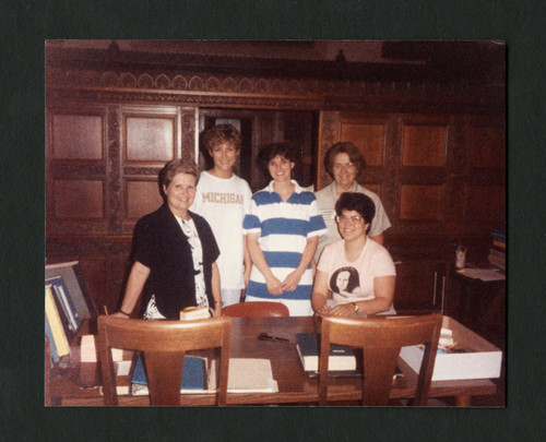 Scripps staff stand together behind Denison Library's front desk, Scripps College