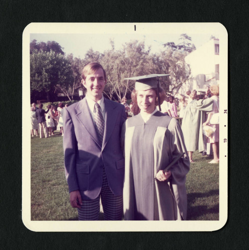 A couple poses for a picture after graduation, Scripps College