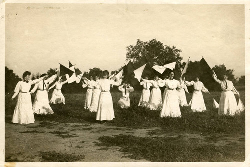 Students performing with flags, Pomona College