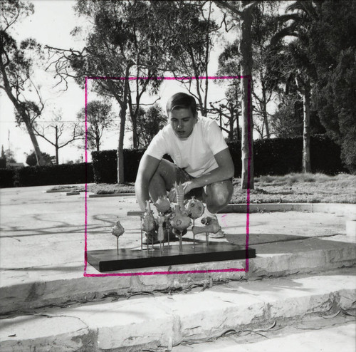 Man with sculptures, Scripps College