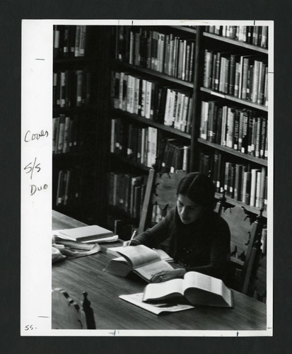 Scripps student studying at a table in Denison Library, Scripps College