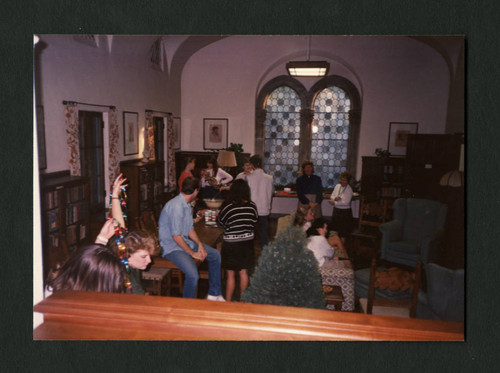 Students and staff mingling at Denison Library's Christmas tea, Scripps College